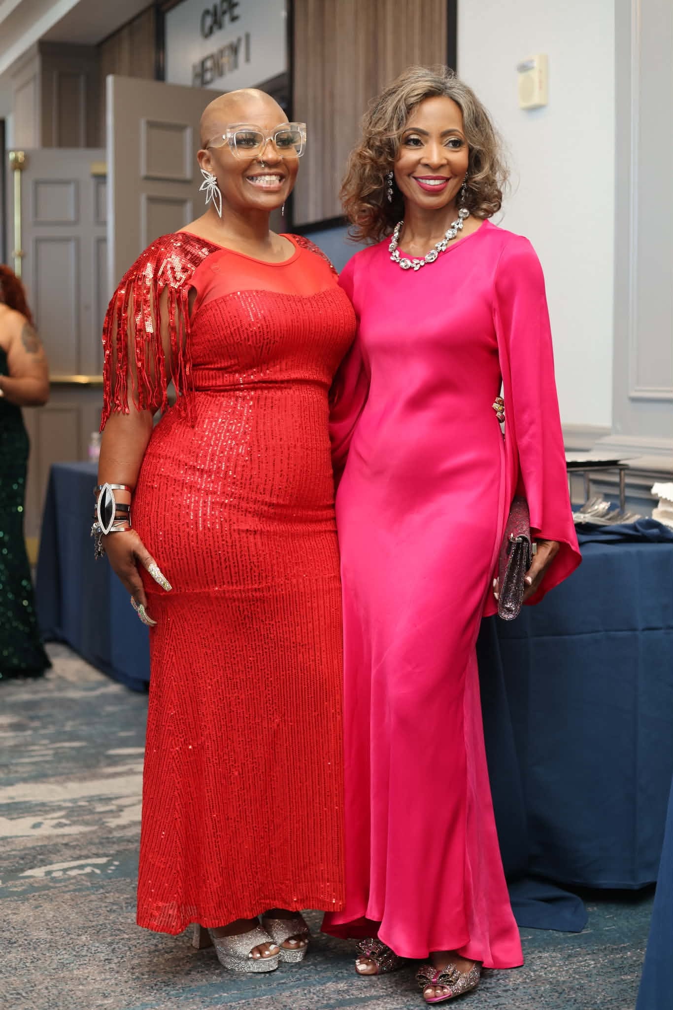 Two Guests in Red and Fuchsia Gowns