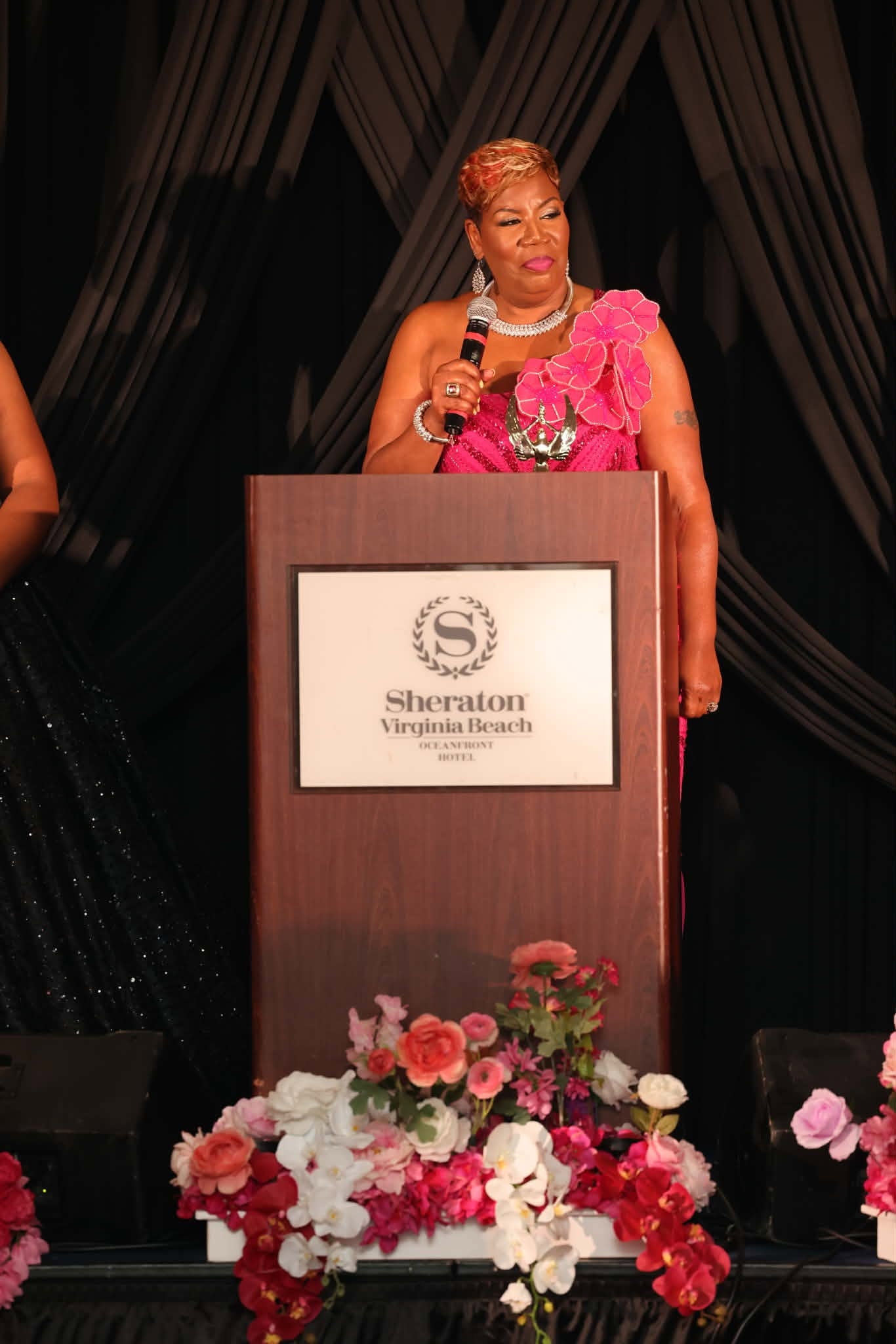 Honoree in Fuchsia Gown at the Podium